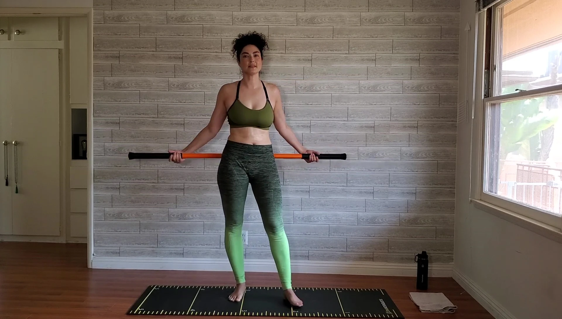 Woman demonstrating the circular arm movements, shown from the front.