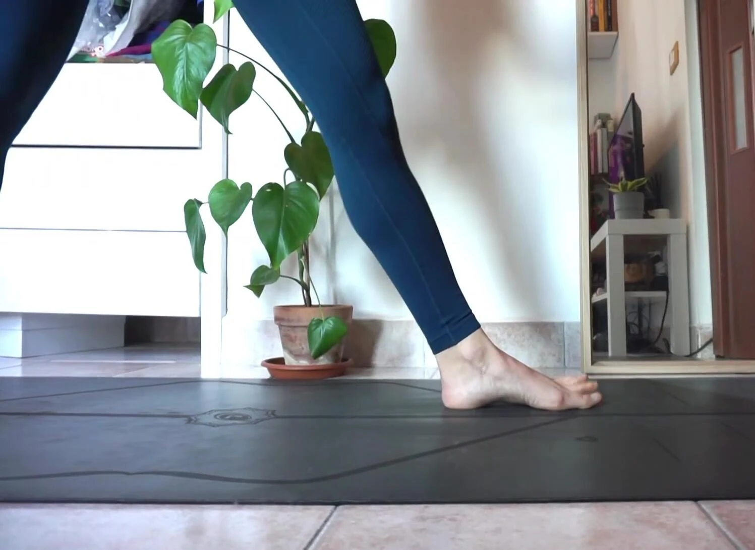 The speaker demonstrating use of a yoga block