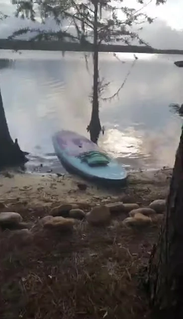 Using the paddle for balance during SUP yoga.