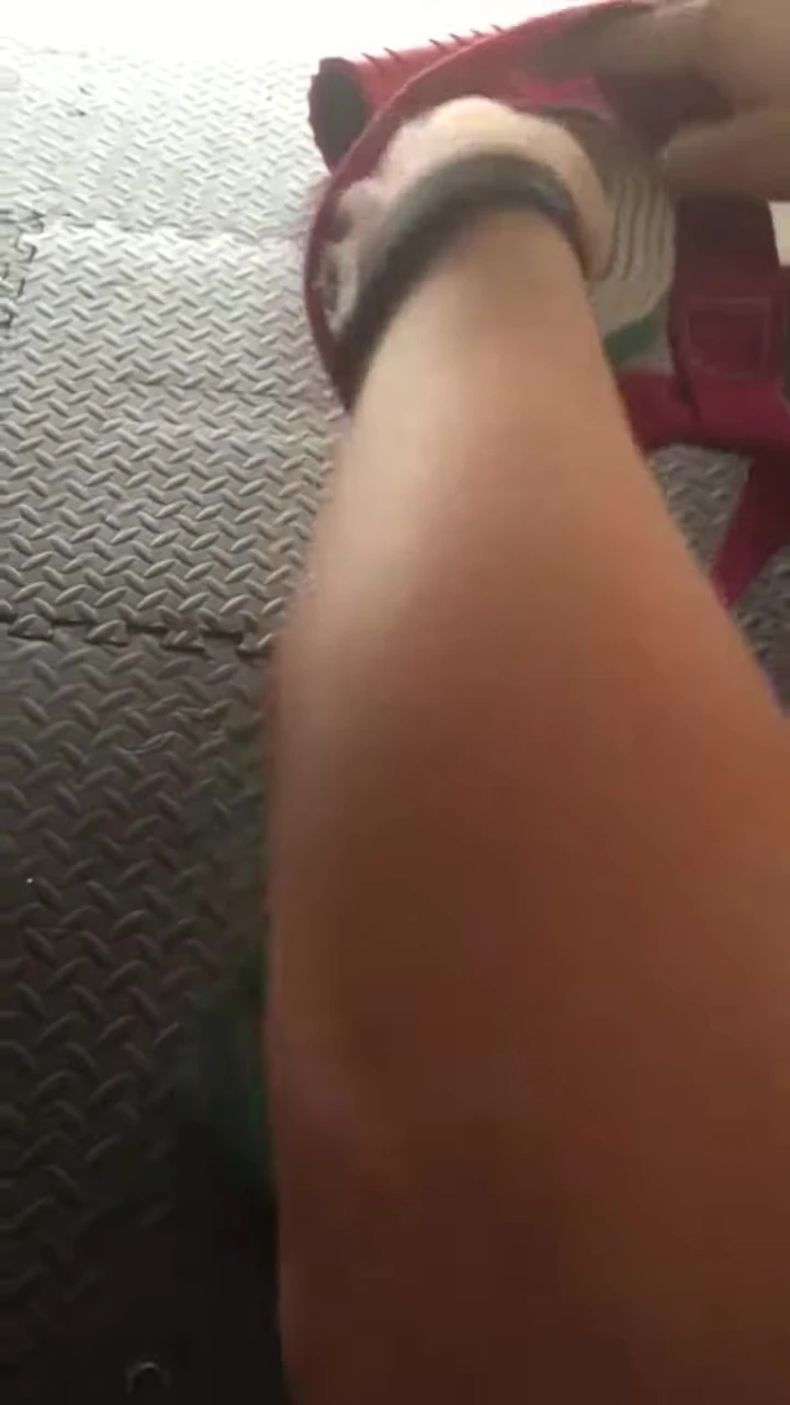 Tucking the strap into the rolled-up yoga mat.