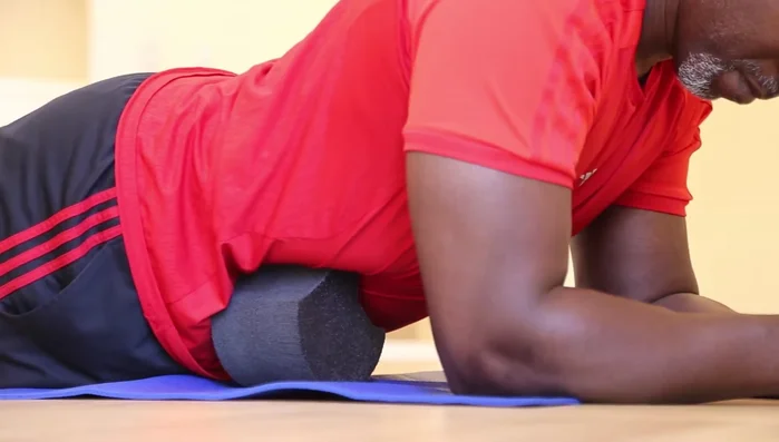 Brace yourself on your forearms and knees. Relax your body, and breathe deeply to release tension.