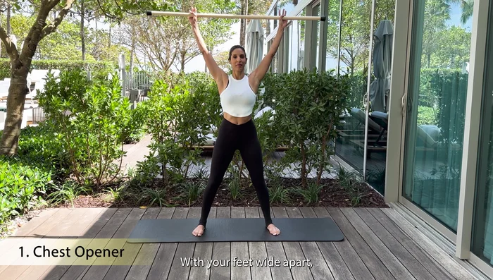 Gradually try to bring the stick further back and down, widening your hands.