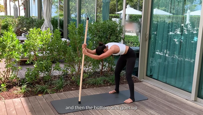 Variation: Climb up the stick, doing cat-cow with one hand on top of the other.