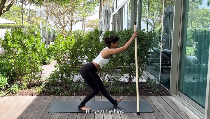 Stay back on one foot, flexing the other, and bend the supporting knee. Hinge at the hips.