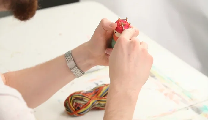 Periodically pull on the bottom strand to tighten and make it easier to continue.