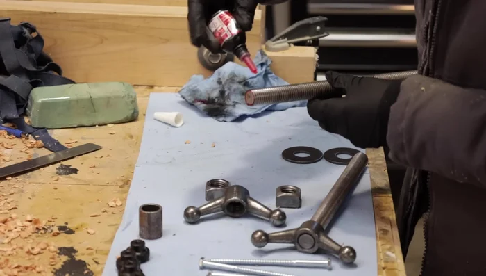 Permanently attach the vise handles to the threaded rods using thread locker.