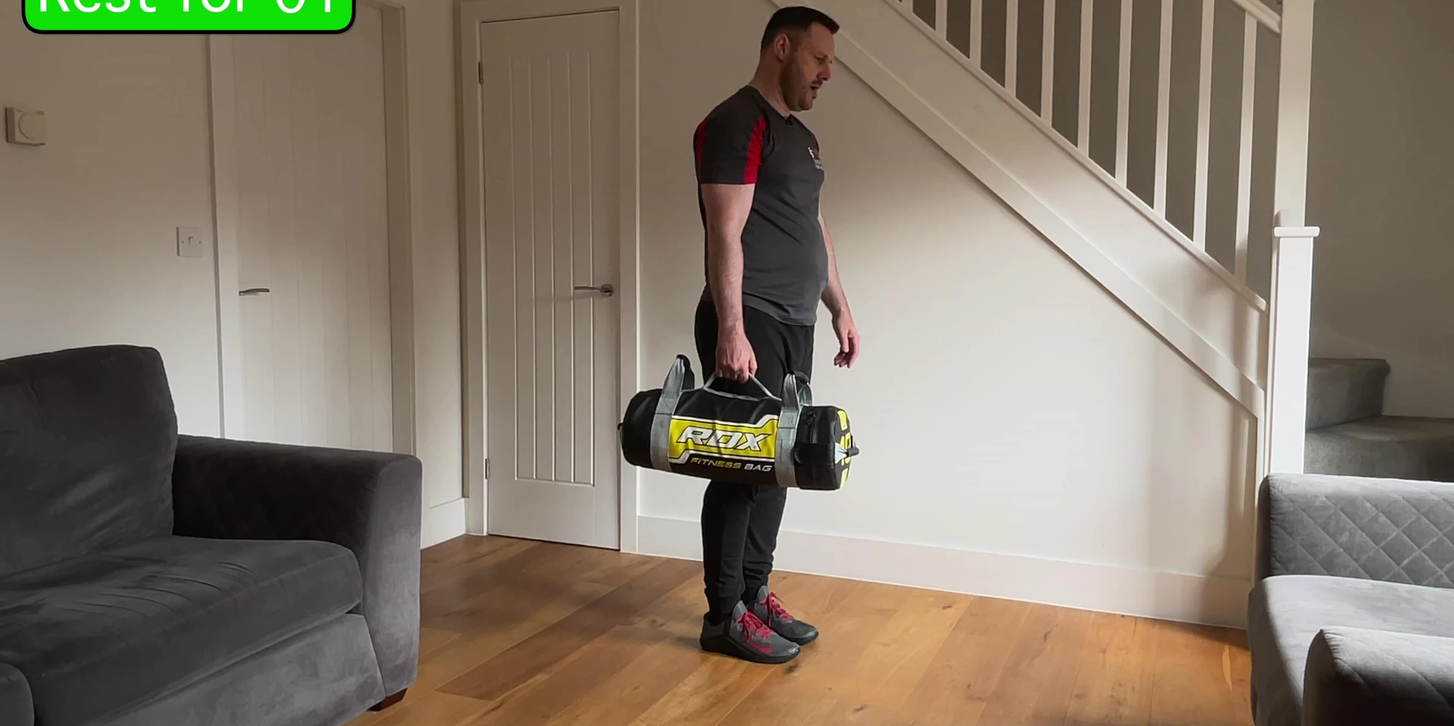 Instructor performing the single-leg Romanian deadlift with row.