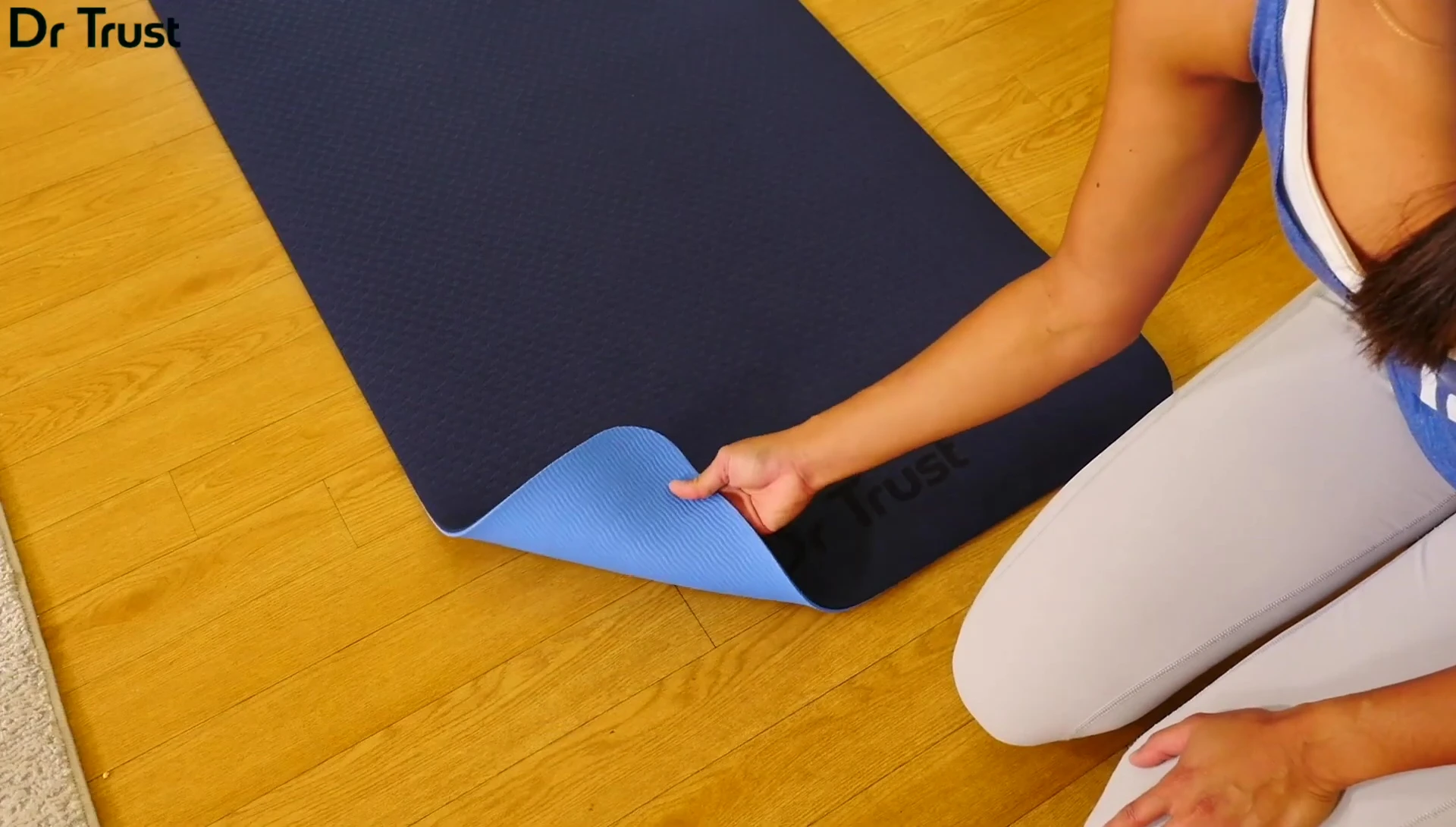 Person demonstrating the mat's softness and support during a workout.