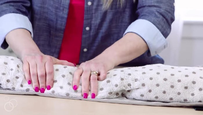 Unroll the towel and lay the item on another dry towel.